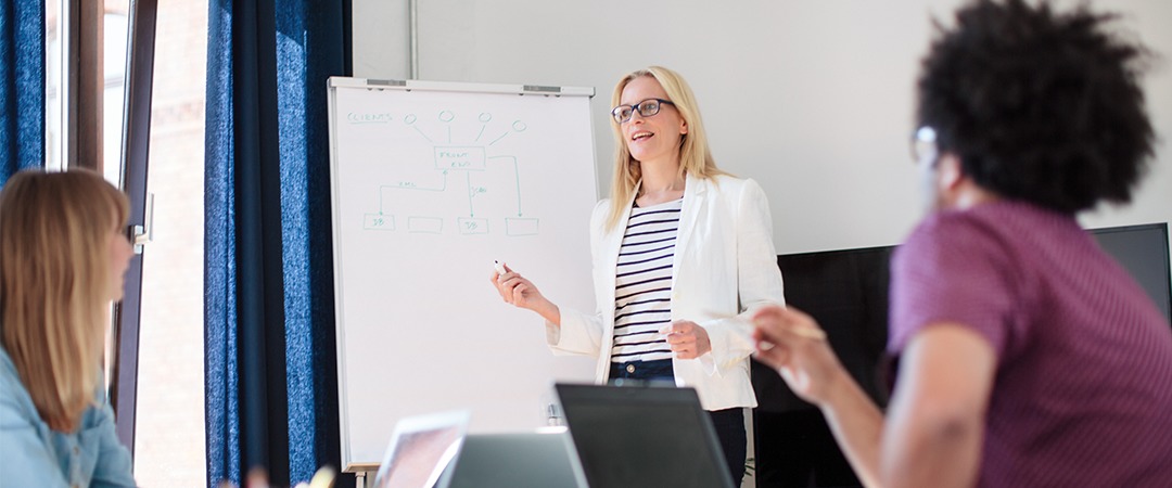 Agency team reviewing strategy at a whiteboard